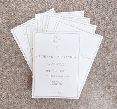 pile of white save the dates with serif font
